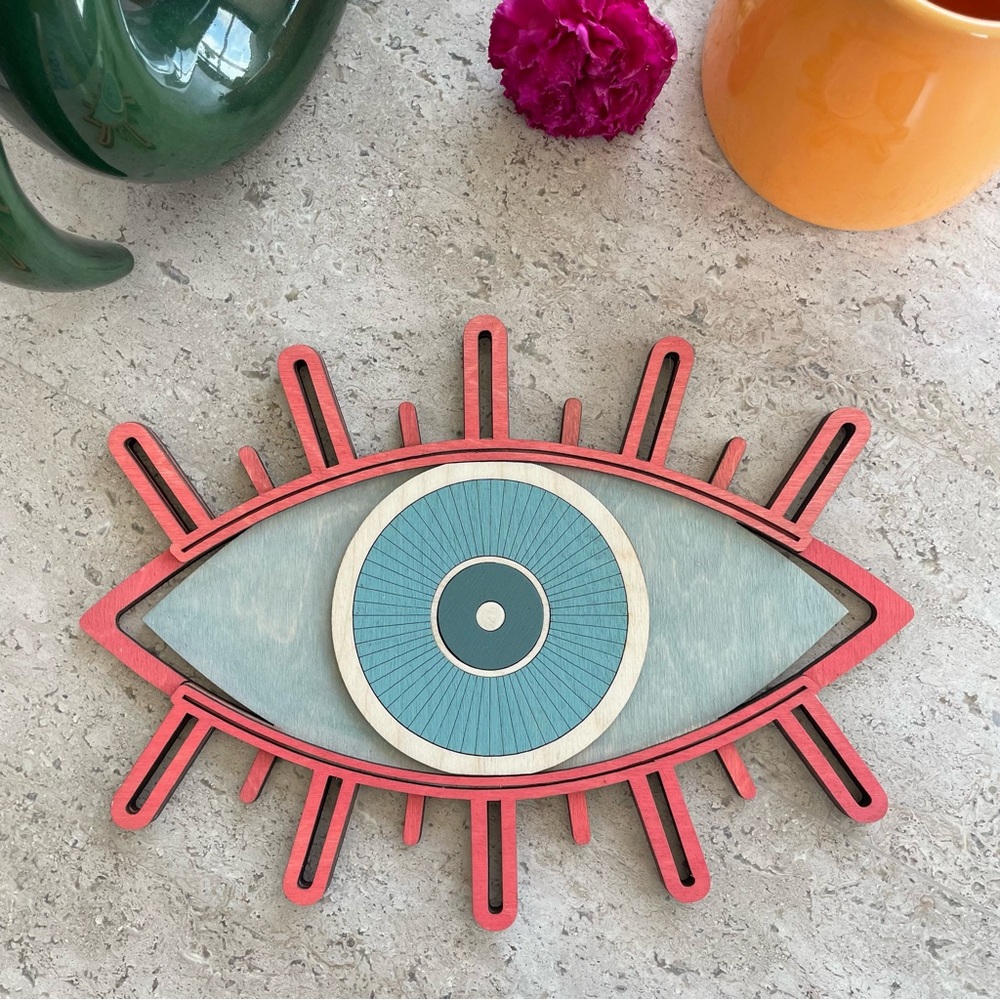 Bright pink evil eye with light blue design